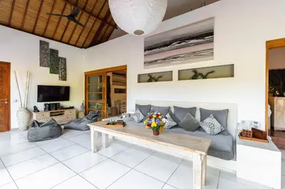 a living room with a couch and a table at Luxurious and Cozy King Beds, Pool, closed living room in Kuta