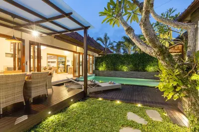 a backyard with a pool and a house at Luxurious and Cozy King Beds, Pool, closed living room in Kuta