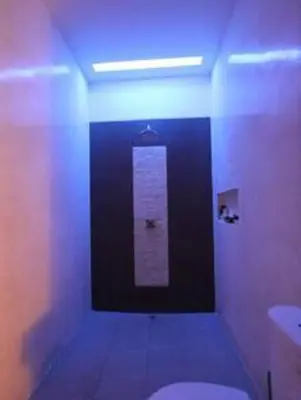 a bathroom with a white toilet and a light at Villa private Pool in Seminyak, Car Park fast WIFI in Kuta