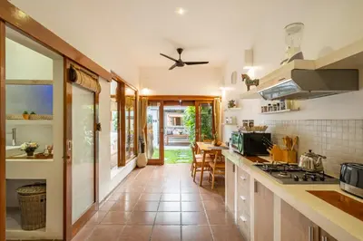 a kitchen with a tile floor and a counter top at Villa private Pool in Seminyak, Car Park fast WIFI in Kuta