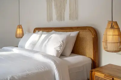 a bedroom with a bed with white sheets and pillows at Nooky 2 - PROMO Seminyak - 2 BDR - Brand NEW Villa - HUGE Pool in Kerobokan
