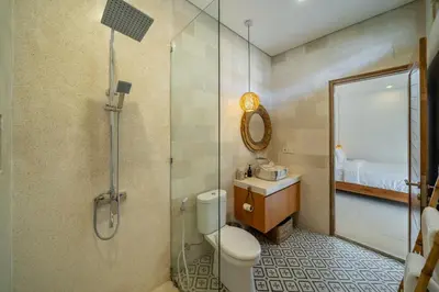a bathroom with a shower and a toilet and a sink at Nooky 2 - PROMO Seminyak - 2 BDR - Brand NEW Villa - HUGE Pool in Kerobokan