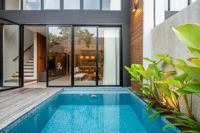 a swimming pool in the middle of a house at Casa Tropicale Seminyak in Seminyak