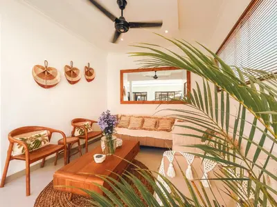 a living room with a couch and a table at Villa Zanetta By Bali Asia Villa in Kerobokan