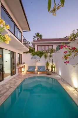 a swimming pool in the backyard of a house at Casa Solace - New! Sparkling villa in the heart of Berawa or Canggu in Canggu