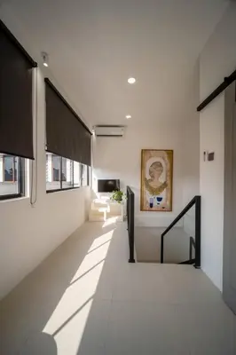 a hallway of a building with white walls and windows at Casa Solace - New! Sparkling villa in the heart of Berawa or Canggu in Canggu