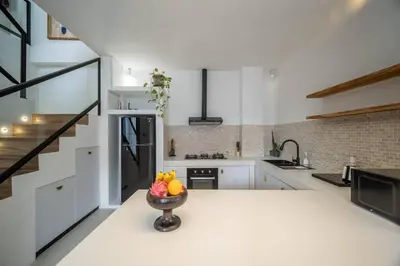 a kitchen with a bowl of fruit on a counter at Casa Solace - New! Sparkling villa in the heart of Berawa or Canggu in Canggu