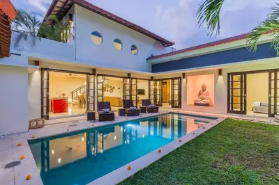 a house with a swimming pool in front of a house at Luxury Hideaway 4 Br Villa 5 minutes to the beach in Seminyak