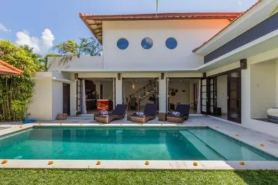 a villa with a swimming pool and a house at Luxury Hideaway 4 Br Villa 5 minutes to the beach in Seminyak