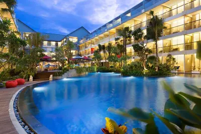 a large swimming pool in front of a building at Ramada Encore by Wyndham Seminyak Bali in Seminyak