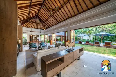 a living room with a couch and a table at Villa Kajou - by Unicorn Villas Bali in Seminyak