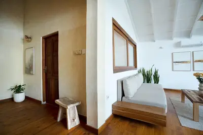 a living room with a bed and a window at Villa Isla Bali in Seminyak