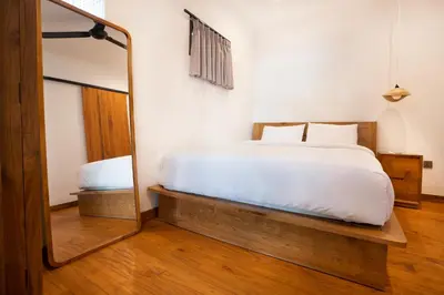 a bedroom with a bed and a mirror at Villa Isla Bali in Seminyak