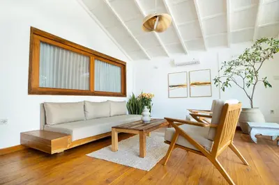 a living room with a couch and a table at Villa Isla Bali in Seminyak