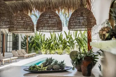 a table with a plate of fruit and pendant lights at Villa Almaz Seminyak in Seminyak