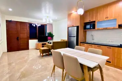 a kitchen and dining room with a table and chairs at Adaline 2 BR Apartment in Jimbaran