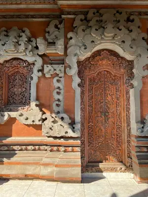 an ornate wooden door on the side of a building at Pondok Ledog 02 in Jimbaran