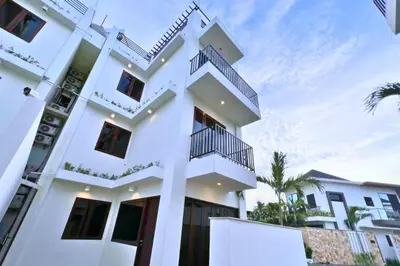 a white building with balconies on it at Lariska 1 BR Superior Queen Room in Jimbaran