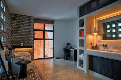 a kitchen with a sink and a table in a room at CARPEDIEM VILLA BALI operated by Villa Nila in Canggu