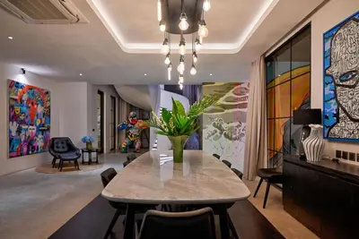a dining room with a table with a vase on it at CARPEDIEM VILLA BALI operated by Villa Nila in Canggu