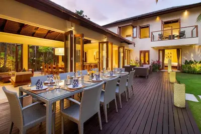 an outdoor dining area with a table and chairs at Super Spacious, 6 Bed, Chef, Daily B'Fast, 12 pax in Seminyak