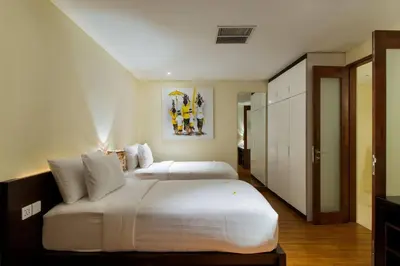 a large bedroom with two beds in it at Super Spacious, 6 Bed, Chef, Daily B'Fast, 12 pax in Seminyak
