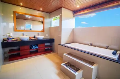 a bathroom with two sinks and a bath tub at Minara 4 BR Private Pool Villa in Canggu