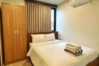 a bedroom with a bed with towels on it at Anyaa 3 BR Apartment in Jimbaran