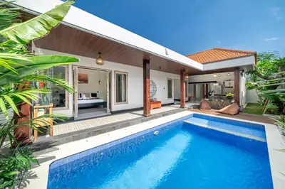 a villa with a swimming pool in front of a house at Villa Thyme, secluded 2 bedroom pool Villa, 2 minutes walking to cafe in Canggu