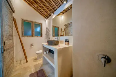 a bathroom with a sink and a toilet at Villa Antea in Seminyak
