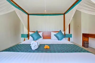 a bedroom with a bed with a stuffed animal on it at Camana 1 BR Villa With Shared Pool in Canggu