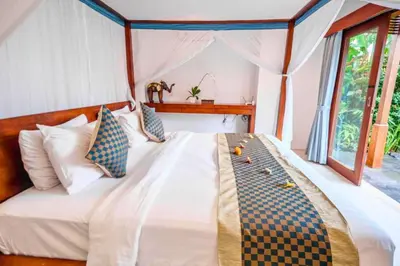 a bedroom with a bed in a tent at Camana 1 BR Villa With Shared Pool in Canggu