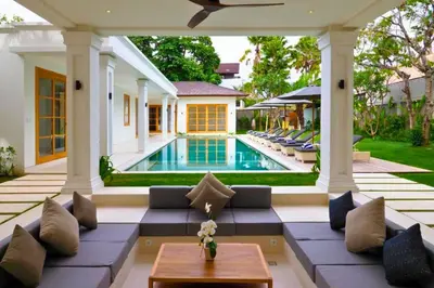 a patio with a couch and a swimming pool at Narasnama 6 BR Private Pool Villa in Canggu