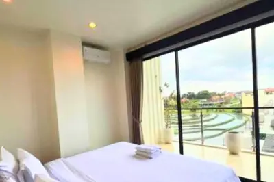 a bedroom with a bed and a large window at Abimana 5 BR Presidential Suite Private Pool in Jimbaran