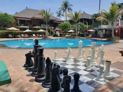 a chess board in front of a pool at C&C Jayakarta Residence Apartment Legian Kuta Bali in Seminyak