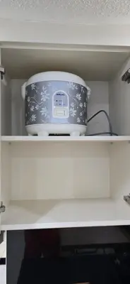 a slow cooker sitting on top of a shelf at C&C Jayakarta Residence Apartment Legian Kuta Bali in Seminyak