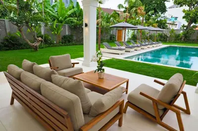 a patio with lounge chairs and a swimming pool at Nawasena 5 BR Private Pool Villa in Canggu