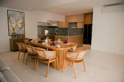 a dining room with a wooden table and chairs at Seminyak Villa Luxury 4BR near Beach Lafavela in Seminyak