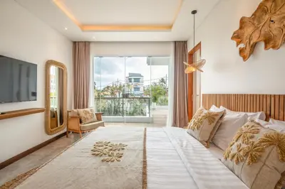 a bedroom with a large bed and a large window at Coastal Elegance 4BR Villa, 400m to Finns in Canggu