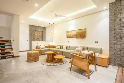 a living room with a couch and a table at Coastal Elegance 4BR Villa, 400m to Finns in Canggu