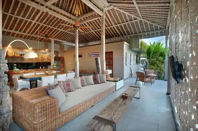 an outdoor living room with a couch and a table at Villa Gahana Bali in Seminyak