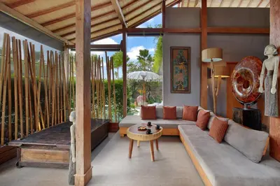 a living room with a couch and a table at Villa Gahana Bali in Seminyak