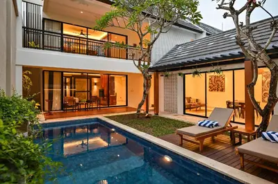 a house with a swimming pool next to a house at The Cabana Villa in Seminyak
