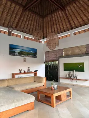 a living room with two couches and a coffee table at Villa Jepun in Canggu