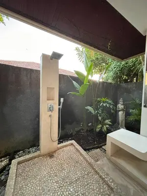 a bathroom with a shower with a garden at Villa Jepun in Canggu