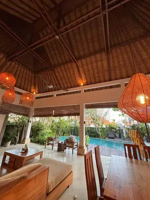 a living room with a couch and a table at Villa Jepun in Canggu