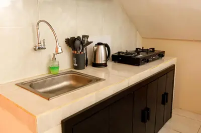 a kitchen counter with a sink and a stove at Villa Majapahit Kuta 5 bedrooms in Legian