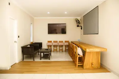 a room with a table and chairs and a piano at Villa Majapahit Kuta 5 bedrooms in Legian