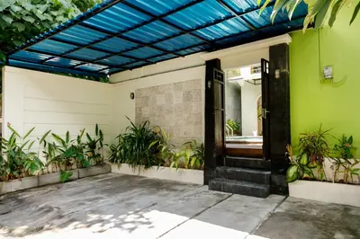 a front door of a house with plants at Villa Majapahit Kuta 5 bedrooms in Legian