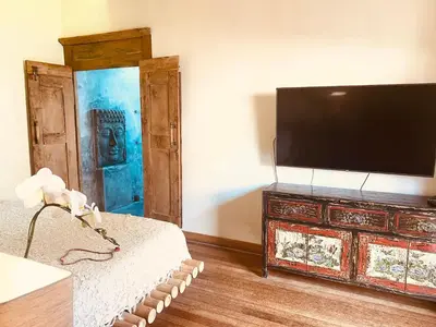 a living room with a flat screen tv on a dresser at Villa Pisces - 2 Bedrooms Villa with Private Pool at Kerobokan in Denpasar